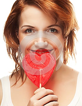 Pretty young woman holding lolly pop.