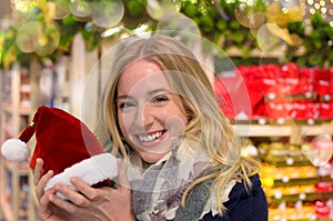 Pretty young woman holding a Santa Claus hat