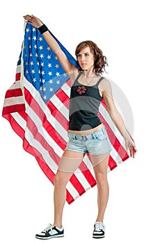 Pretty young woman holding a USA flag behind herself
