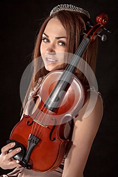 Pretty young woman holding a violin