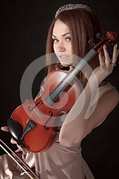 Pretty young woman holding a violin