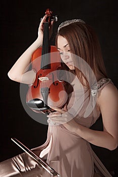 Pretty young woman holding a violin