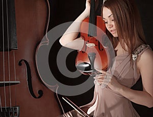 Pretty young woman holding a violin