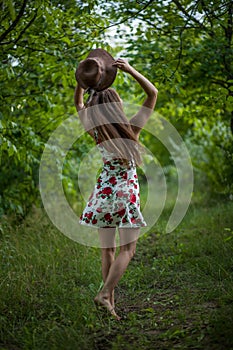 Pretty young woman jumping on green park