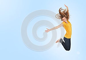 Pretty young woman jumping for joy