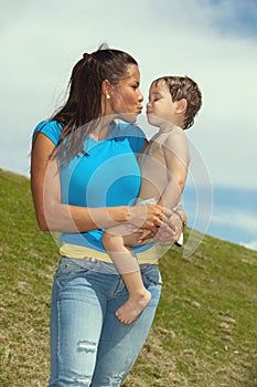 Pretty young woman kissing a cute boy