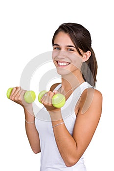 Pretty young woman lifting dumbbells