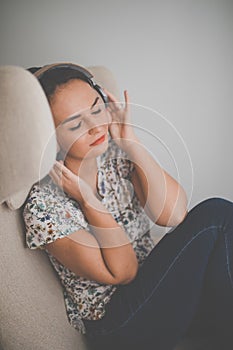 Pretty, young woman listening to her favorite music