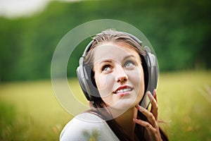 Pretty young woman listening to music