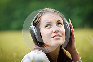 Pretty young woman listening to music