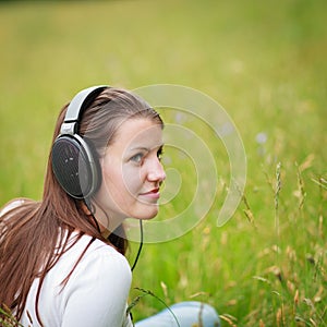 Pretty young woman listening to music