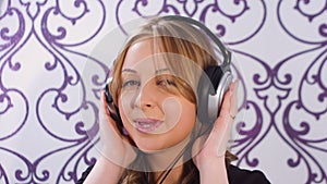 Pretty young woman listening to music at home