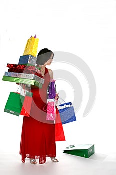 Pretty young woman loaded down with gift bags