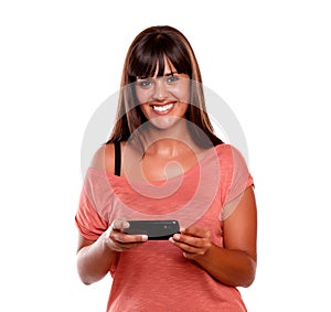 Pretty young woman looking at you using mobile