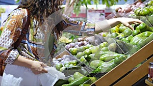 Pretty young Woman or Mother buys food, vegetables, avocado, fruits, carrots, cabbage, salad, cauliflower, meat, apples