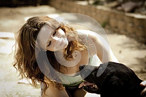 Pretty young woman petting her dog