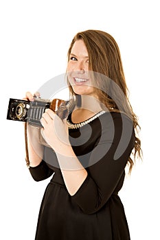 Pretty young woman photographer holding an antique camera