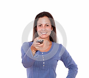 Pretty young woman pointing remote control