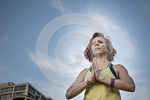 Pretty Young Woman Practicing Yoga in the Park (Prayer Hands) (Tree Pose)