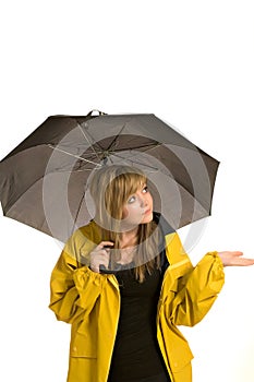 Pretty young woman in raincoat with umbrella