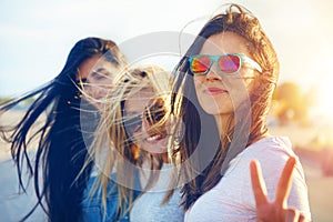 Pretty young woman raises to fingers as peace sign