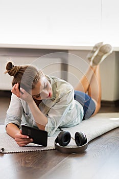 Pretty young woman reading an e-book