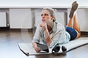 Pretty young woman reading an e-book