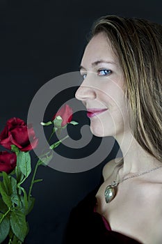 Pretty young woman with red roses