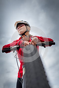 Pretty, young woman riding her mountain bike