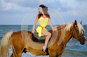 Pretty young woman riding a horse