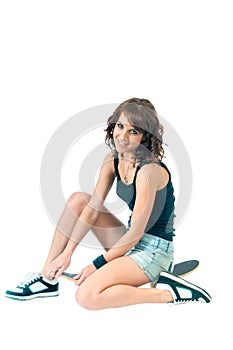 Pretty young woman sitting on a skateboard