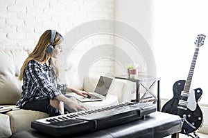 Female musician composing music at home photo