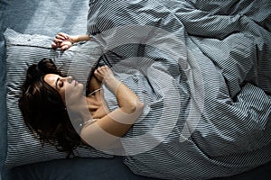 Young woman sleeping in her bed photo
