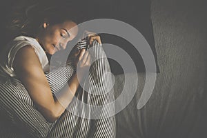 Pretty, young woman sleeping in her bed late in the morning