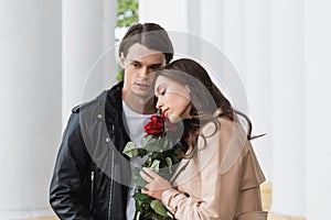 pretty young woman smelling red roses