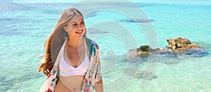 Pretty young woman smiling relaxing on summer beach sunbathing banner panorama