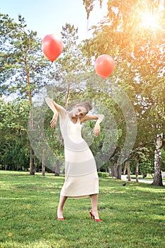 Pretty young woman stand on grass. Fashion model doll concept