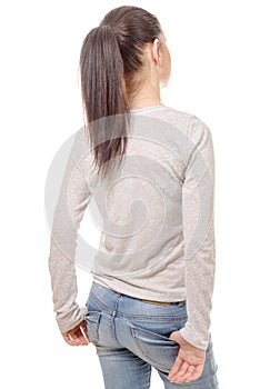 Pretty young woman standing on white background, back view