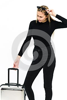 Pretty young woman with suitcase on white background