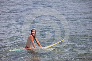 Pretty Young Woman on a Surfboard