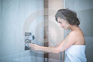 Pretty, young woman taking a long hot shower