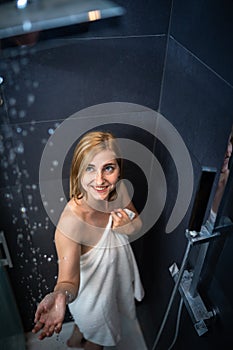 Pretty, young woman taking a long hot shower