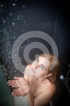 Pretty, young woman taking a long hot shower