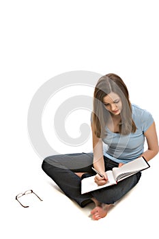 Pretty young woman taking notes