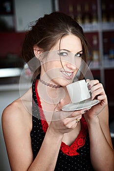 Pretty Young Woman Tasting Coffee