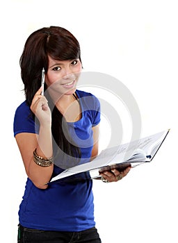 Pretty young woman thinking, holding pen