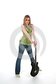 Pretty young woman in tight jeans with a guitar