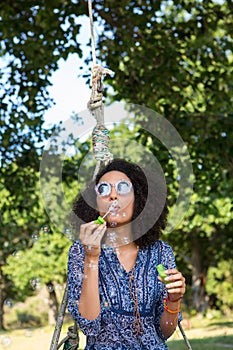 Pretty young woman in tire swing