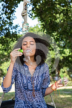 Pretty young woman in tire swing