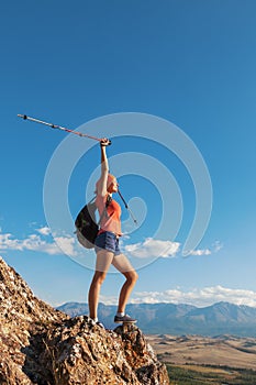 Pretty young woman tourist standing on top of moun